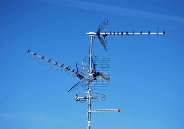 Outdoor TV Antenna on a building with sky background